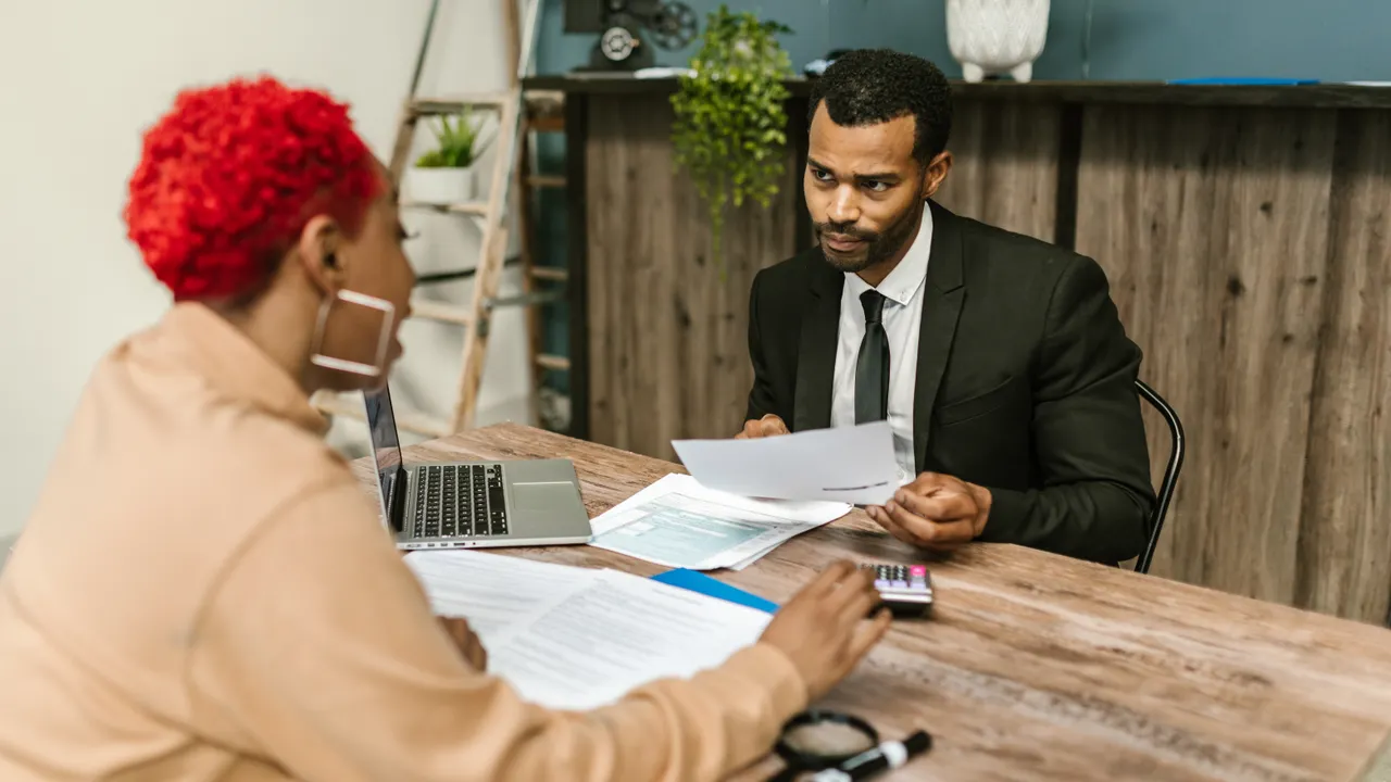 A tax professional reviewing documents with a client